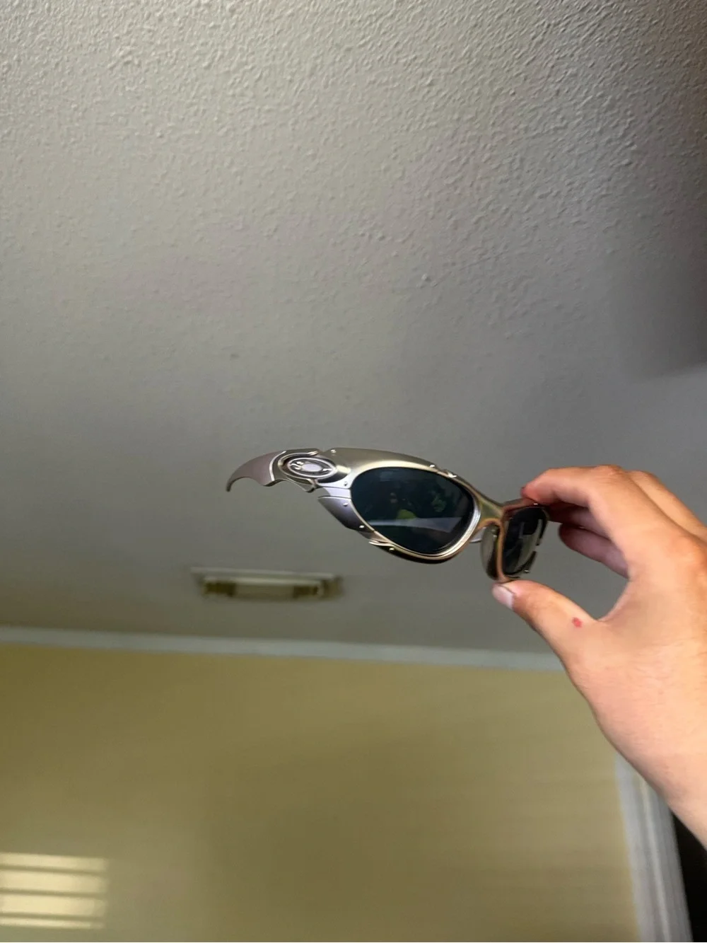 Futuristic Silver Sunglasses with Dark Lenses Oakley